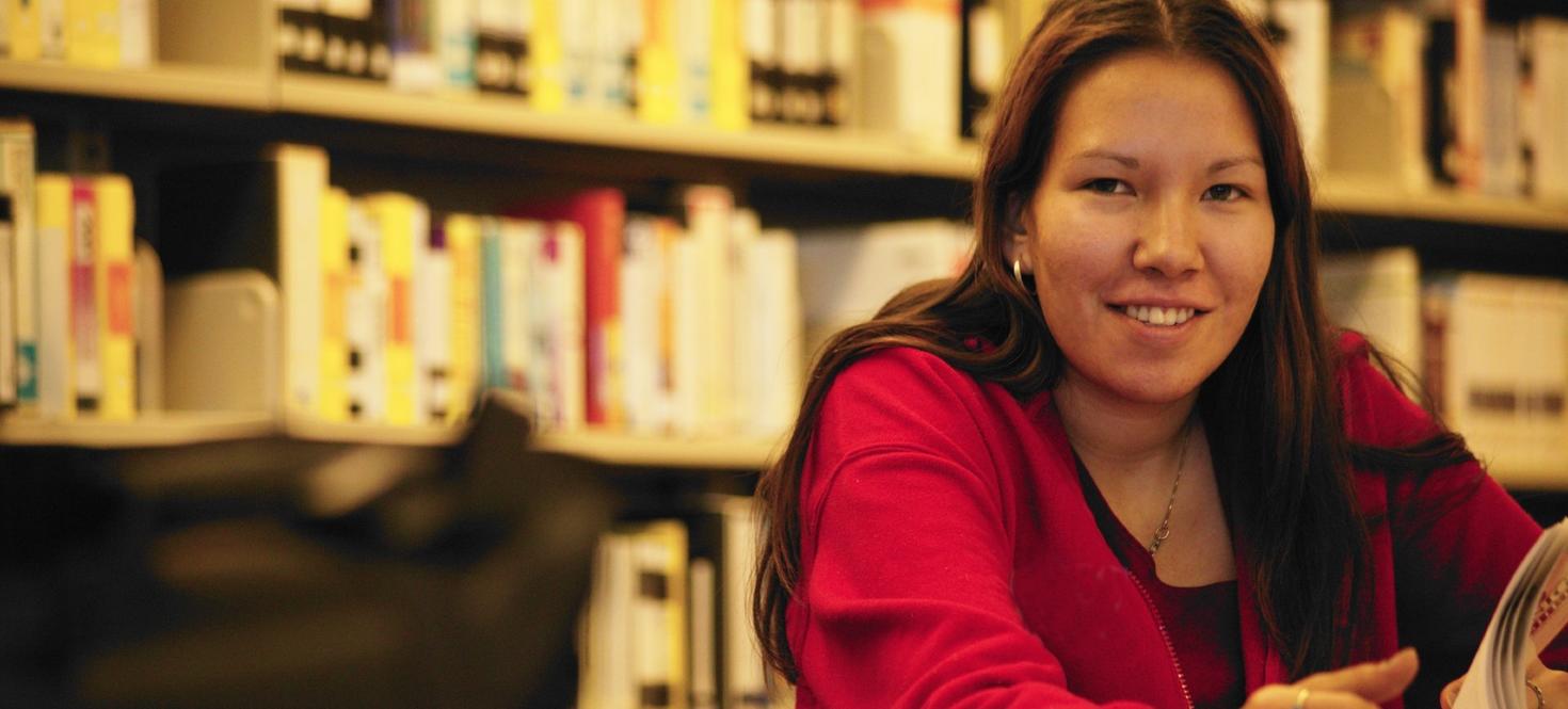 Indigenous woman studying in the library