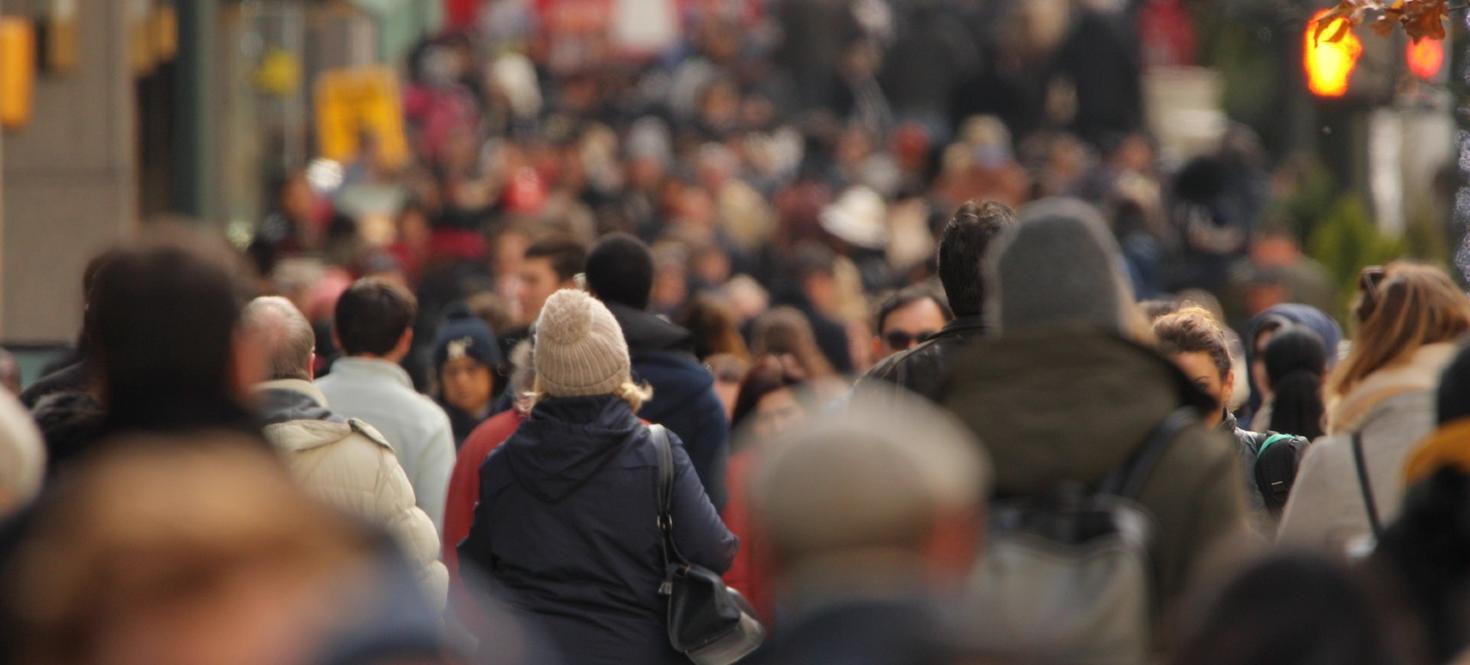 large crowd of people on a sidewalk
