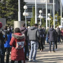 A group of people standing in line outside