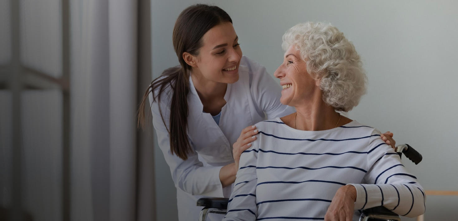 Specialist helping a senior woman in a wheelchair