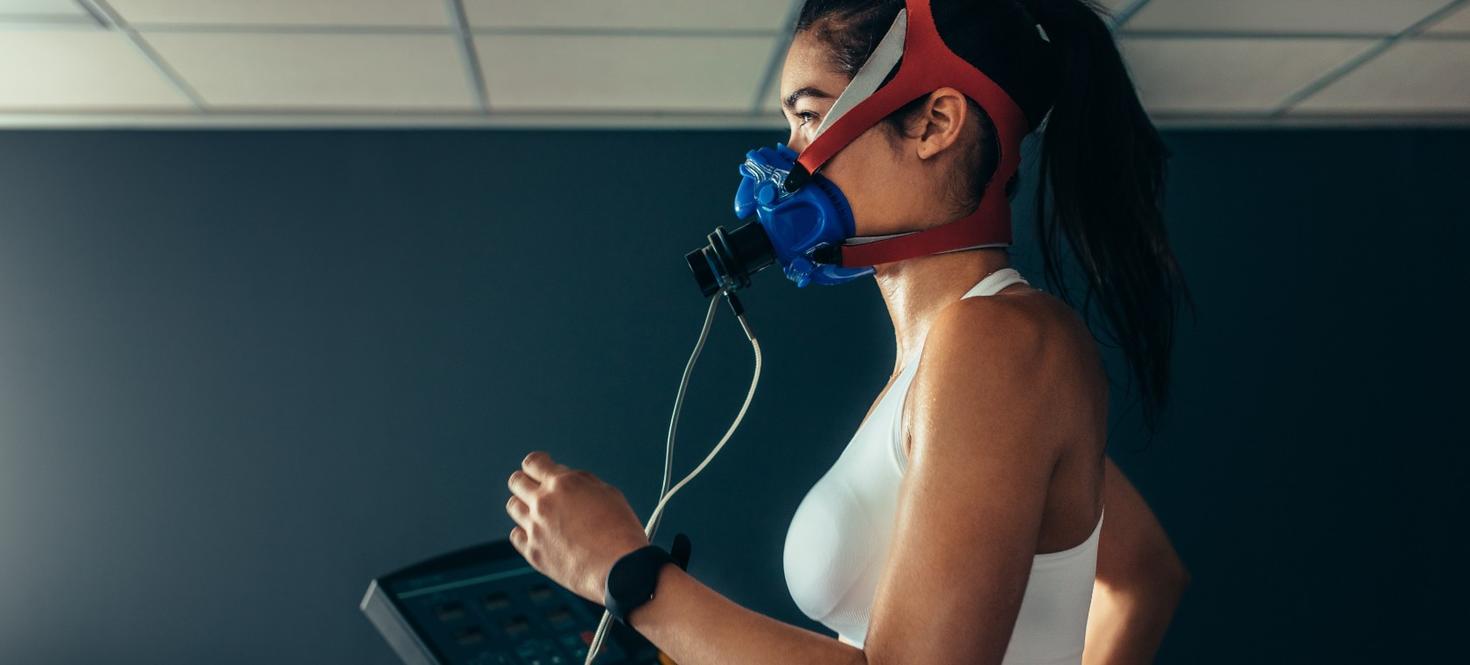 Woman running on treadmill with biomechanic monitoring equipment