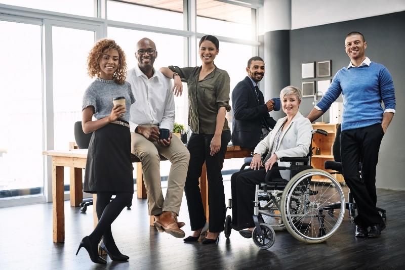 A group of people stand around a table