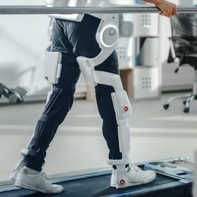 Man using robotic exoskeleton on treadmill.