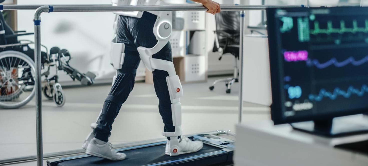 Person walking on a treadmill with an exoskeleton leg