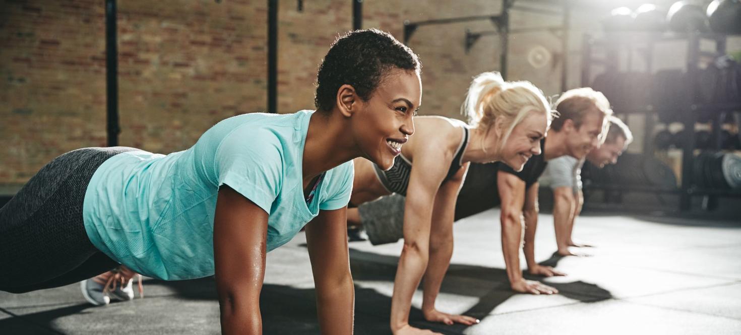 A row of young people doing pushups