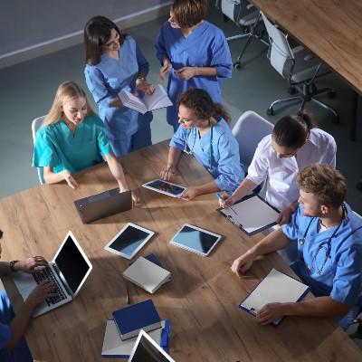 A group of nursing students sit at desks in a classroom