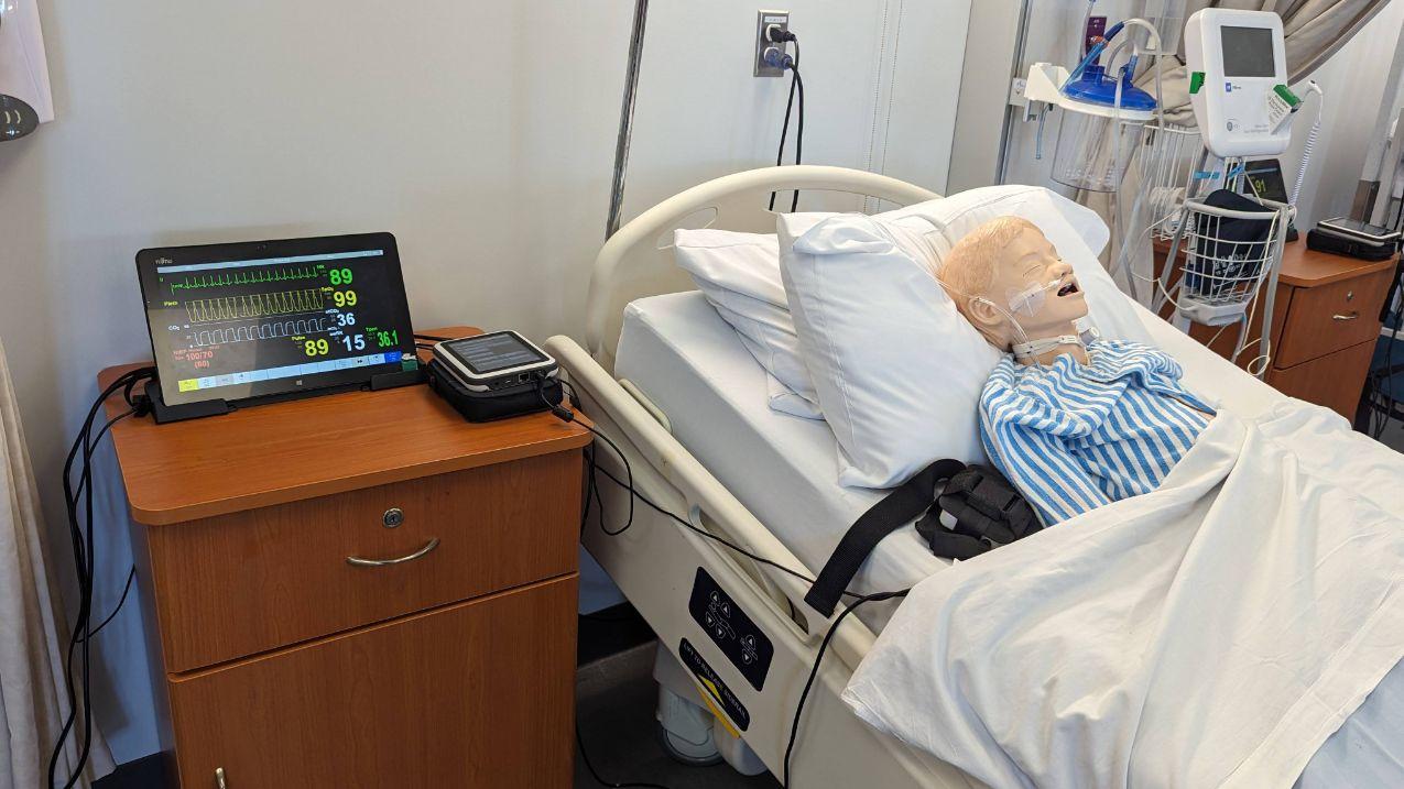 Nursing mannequin in a realistic hospital setting