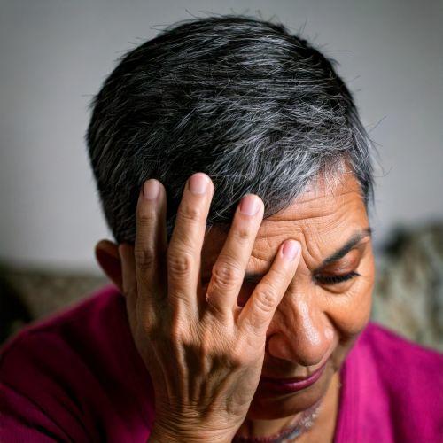 woman holding her head 