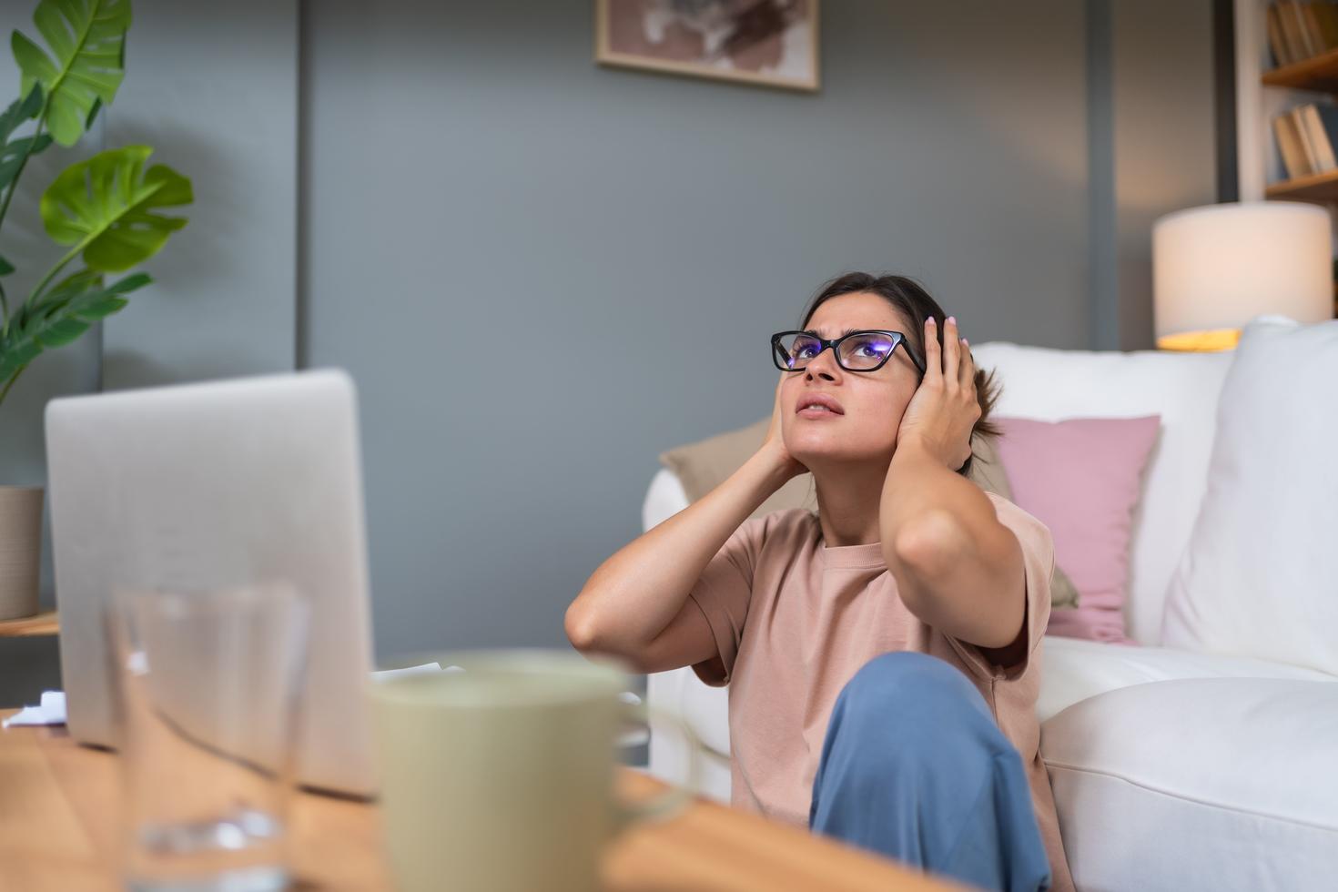 A woman annoyed by noise coming from upstairs