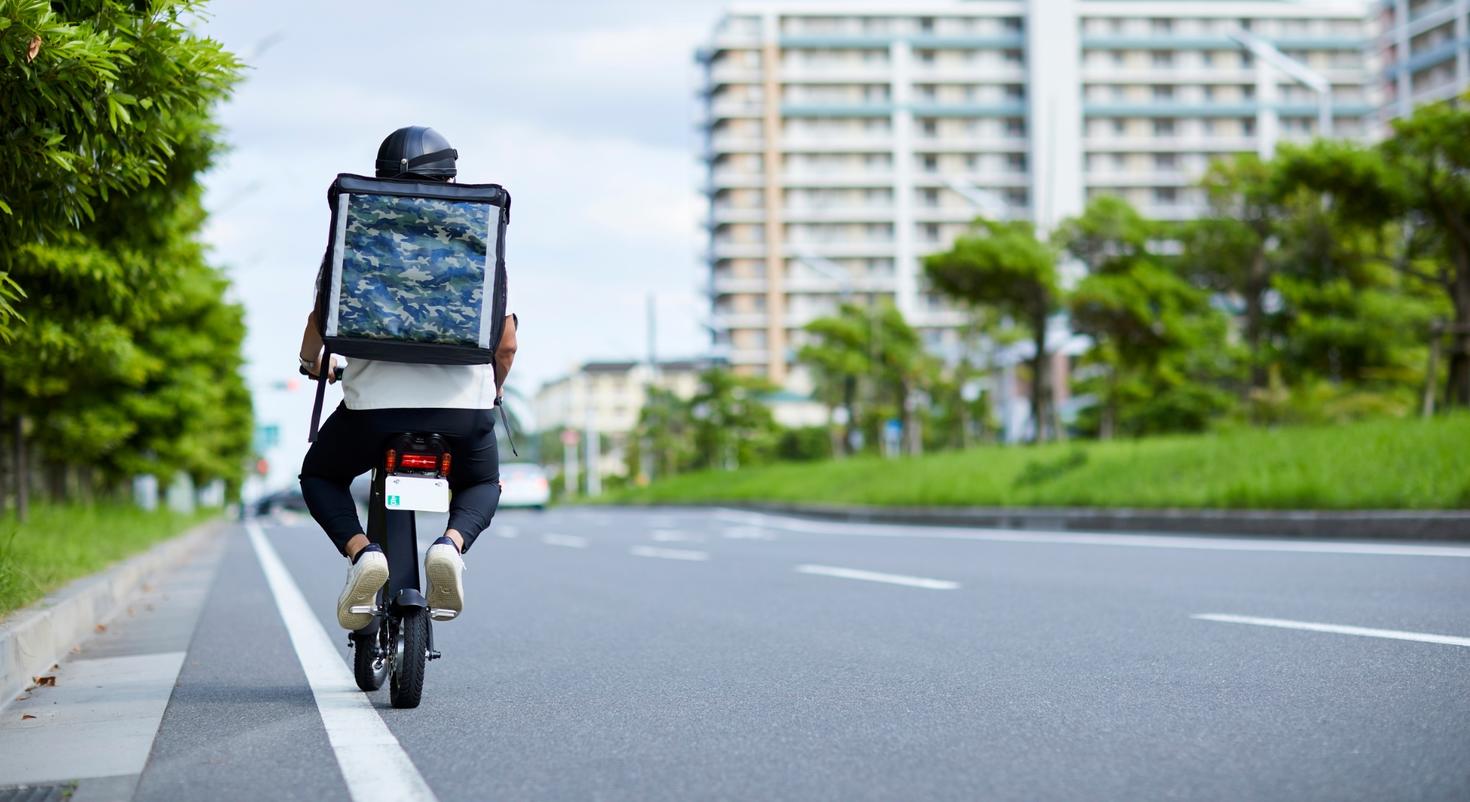 A man riding a bicycle down the street.