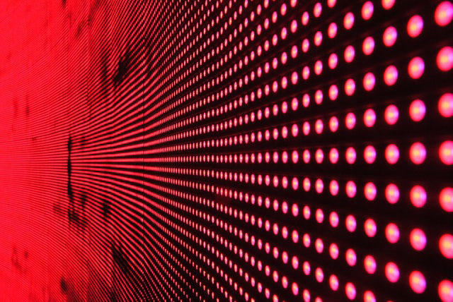A bold red wall featuring an array of lights
