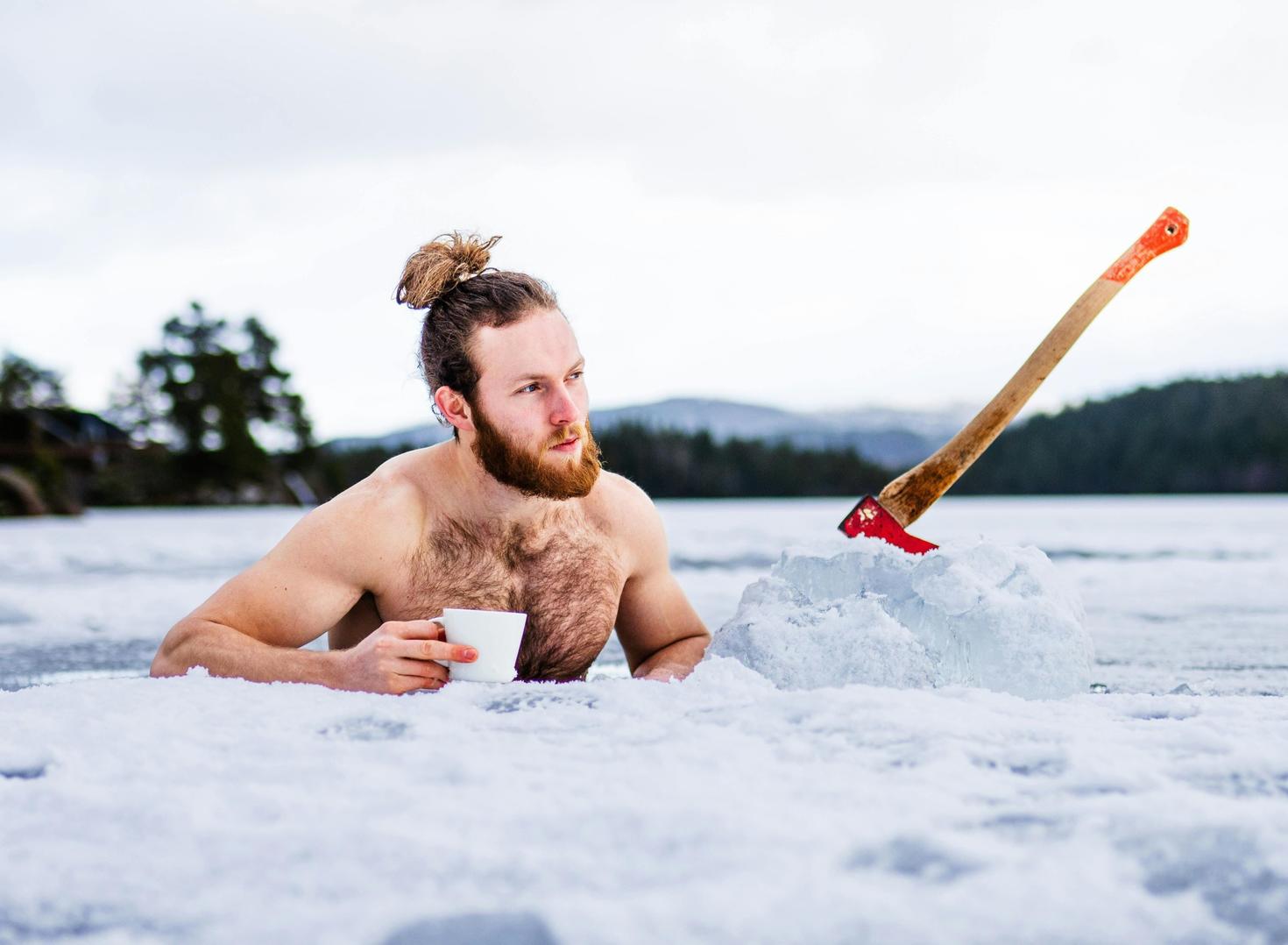 Man drinking coffee in an iced lake