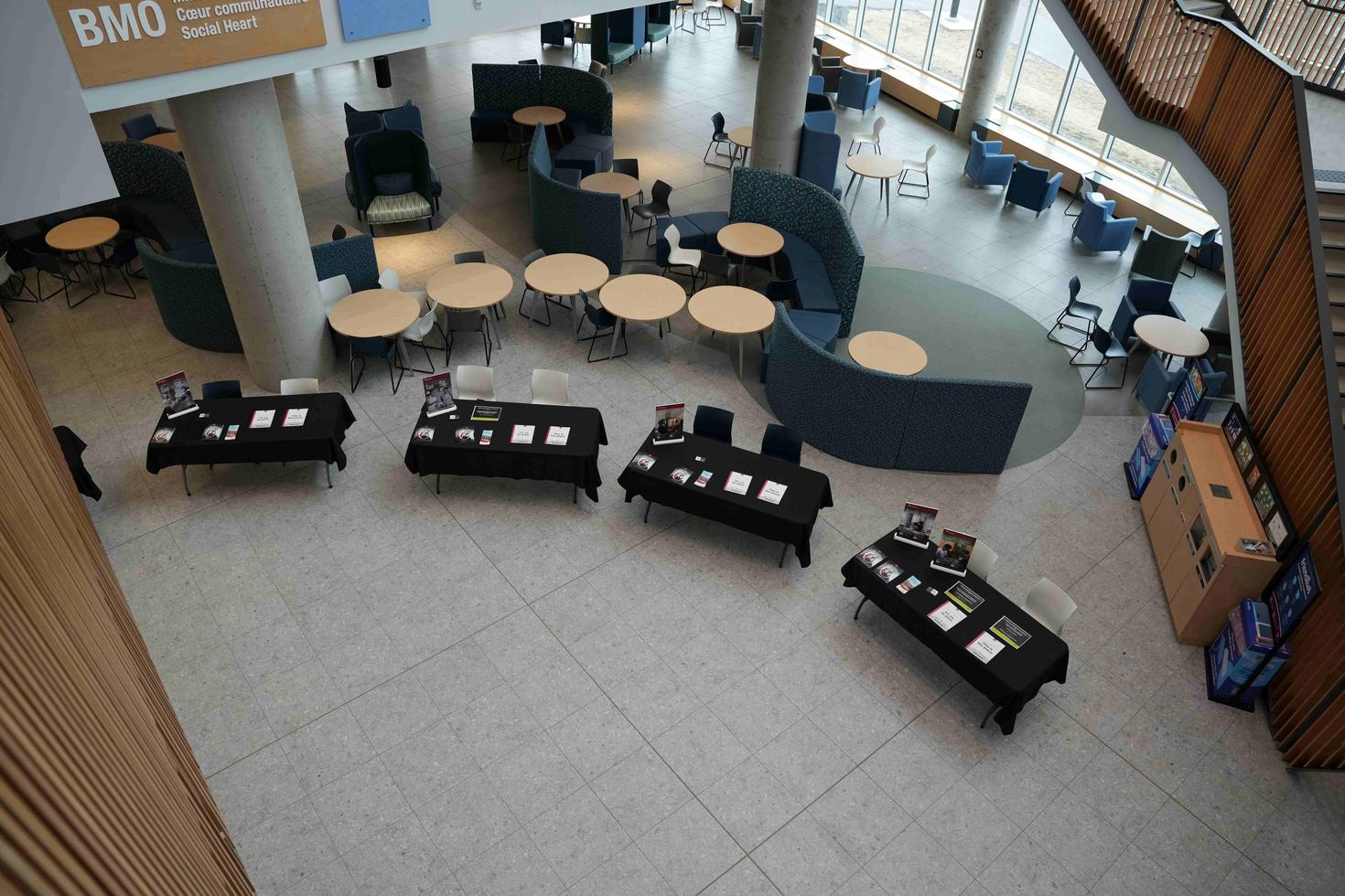 Program information tables are set up in the BMO Social Heart at 200 Lees.
