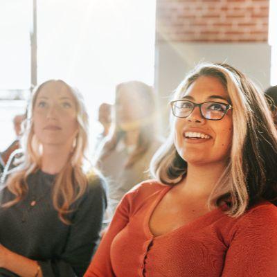 A group of people watching a presentation