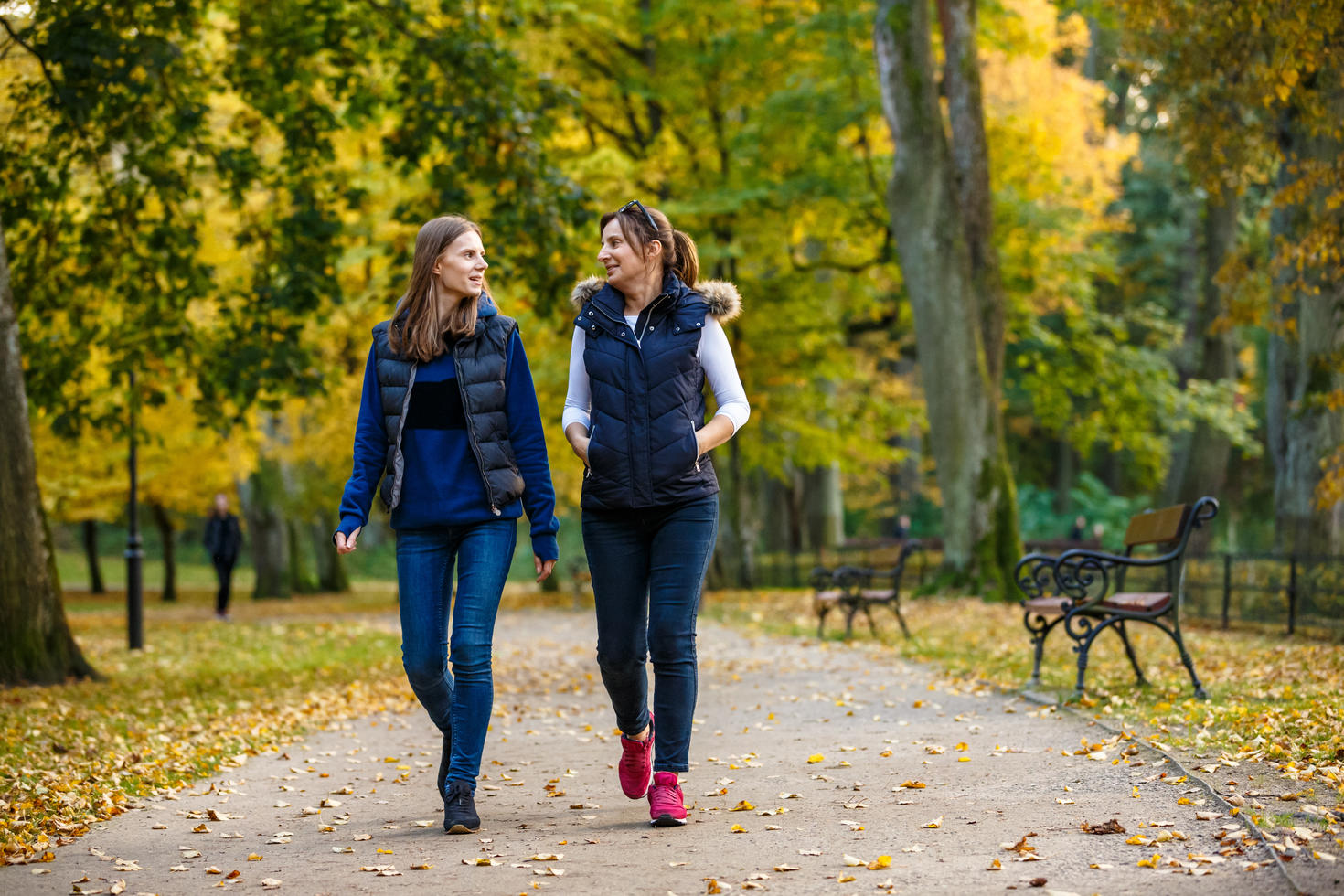 Two people walking in a park 