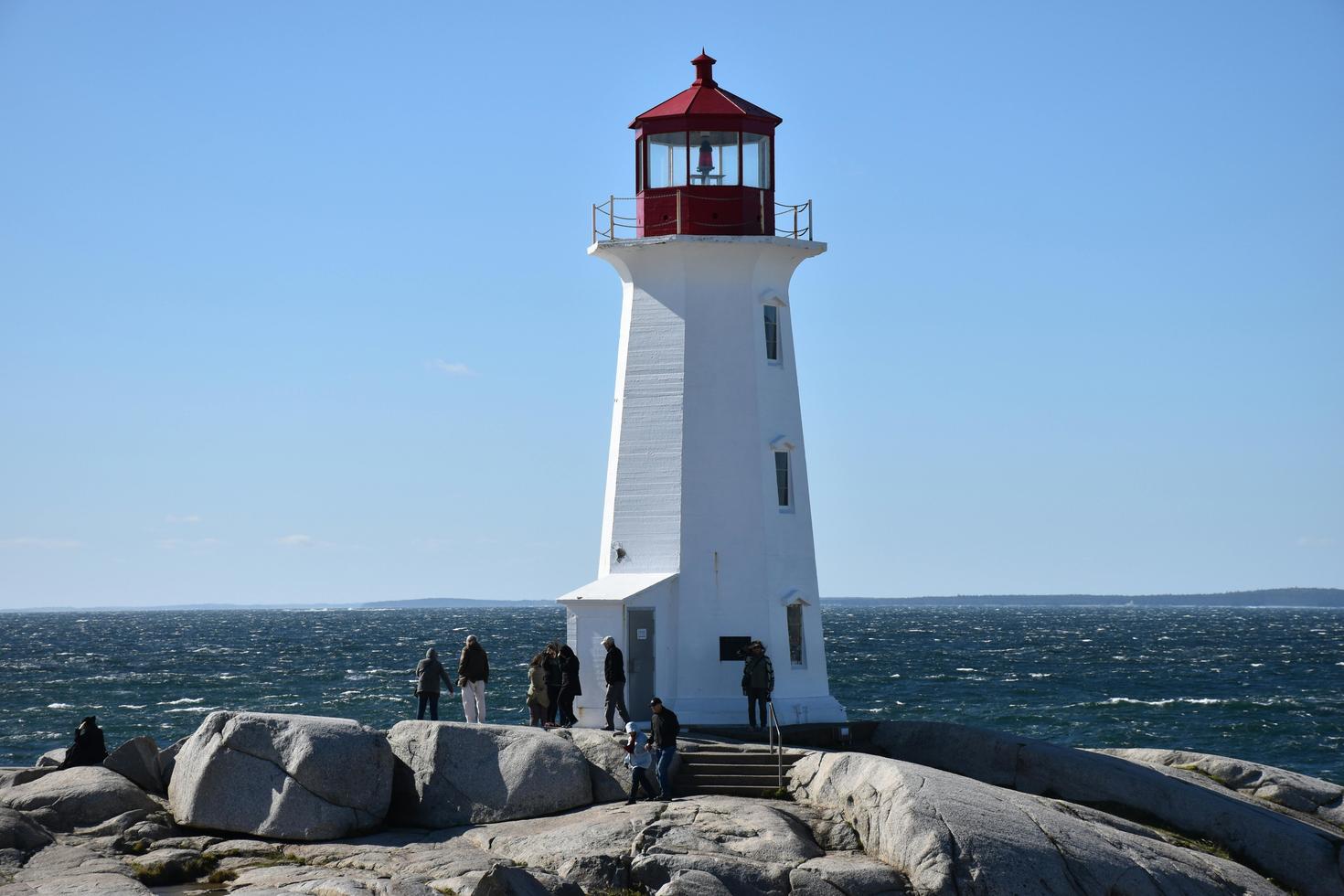 Peggy’s Cove Lighthouse historic site and Atlantic Ocean coastline in Nova Scotia, Canada.