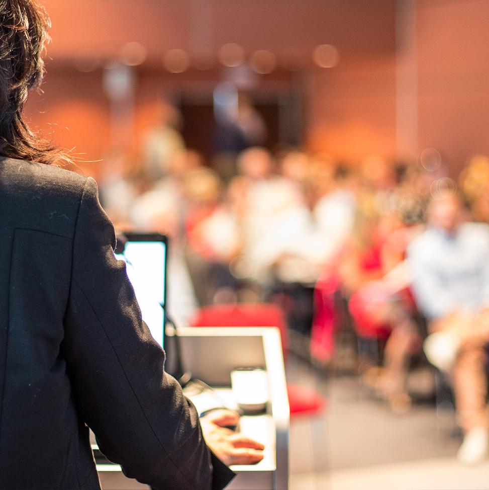 person presenting at a podium