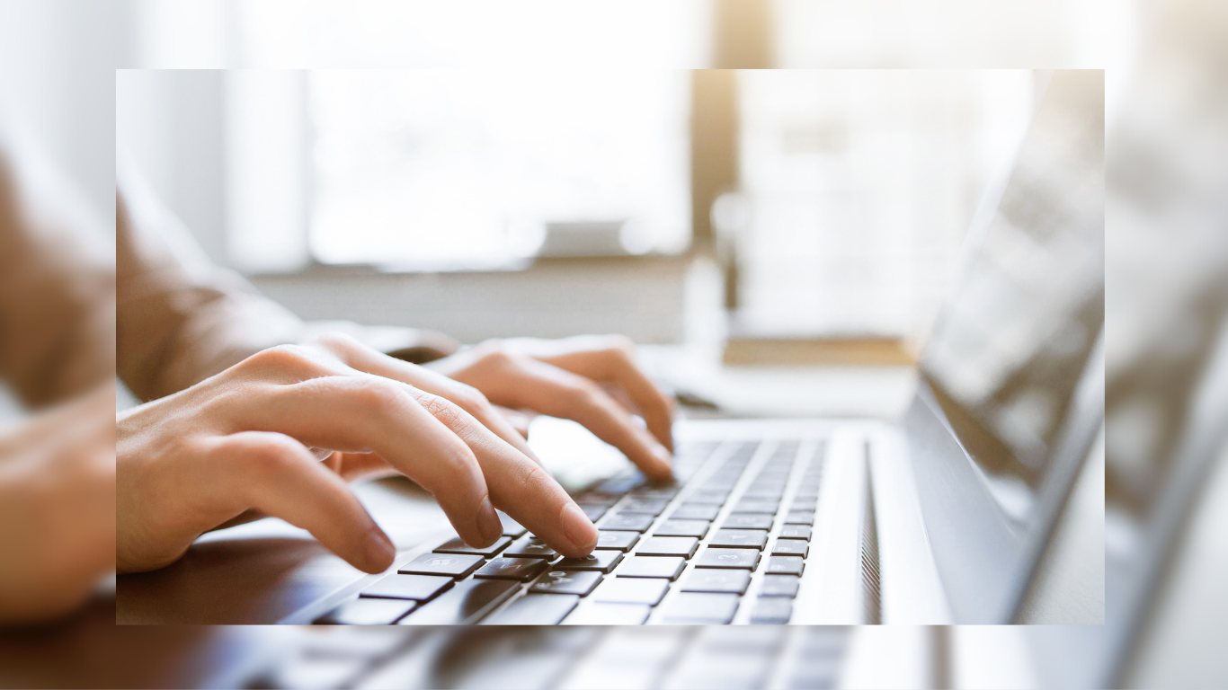 Student typing on a laptop