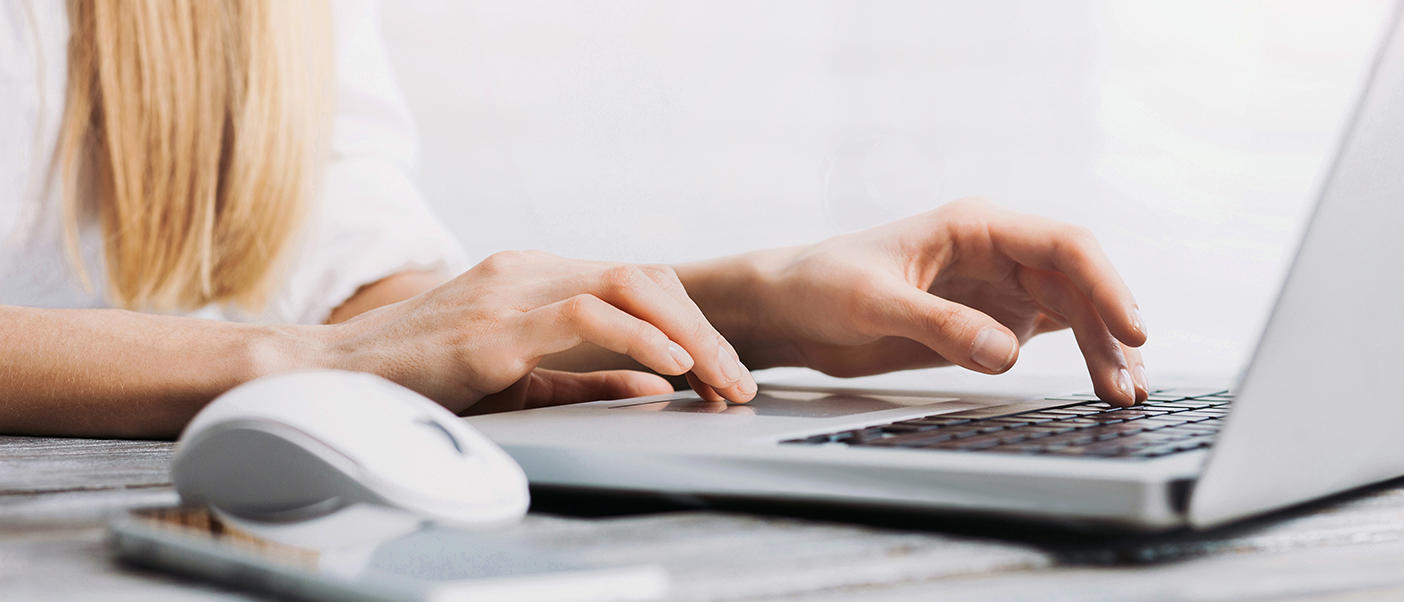 Person typing at a laptop