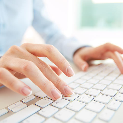 hands typing on keyboard