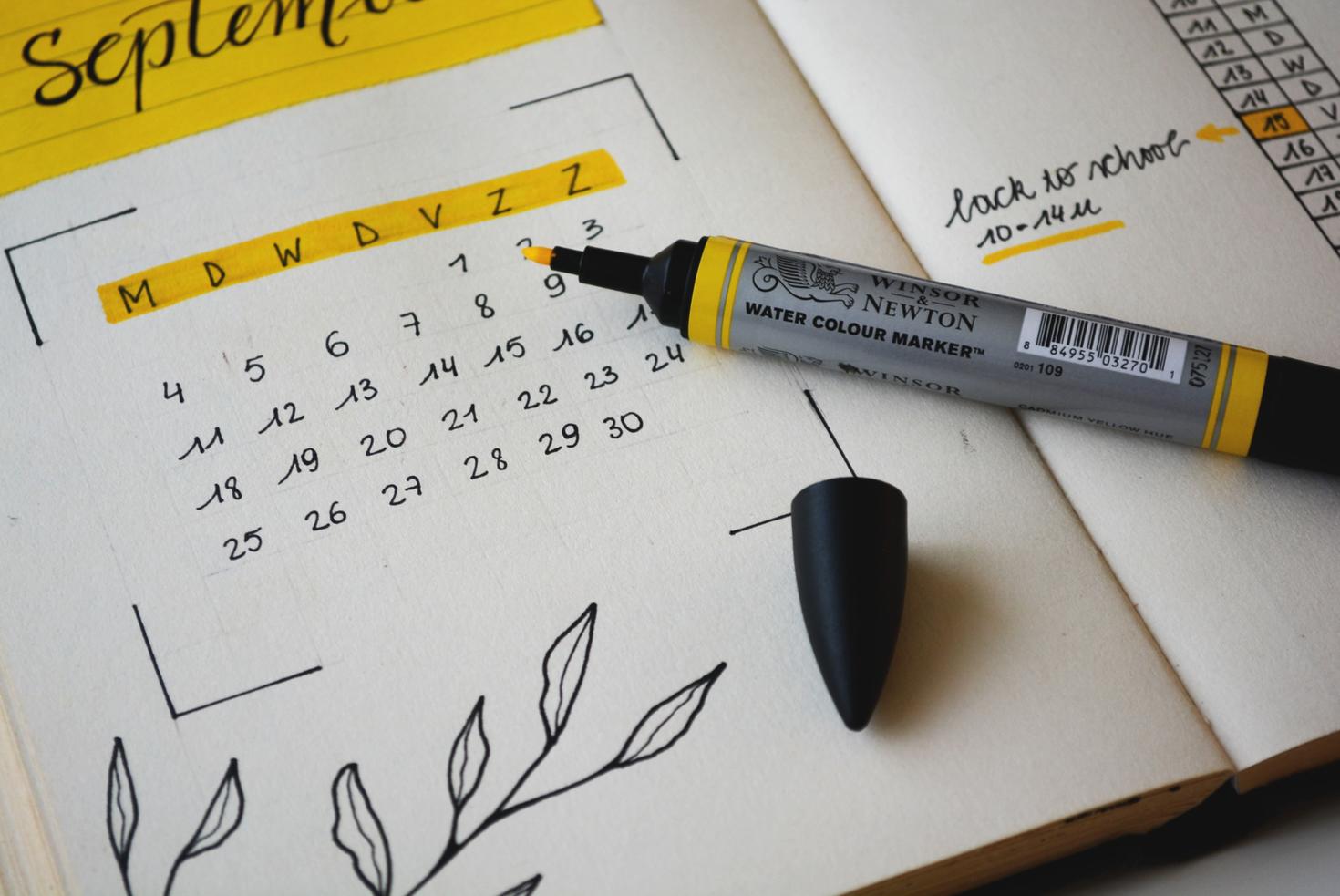 open notebook with dates highlighted on calendar