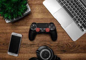 silver-macbook-beside-black-sony-ps4-dualshock-4-silver
