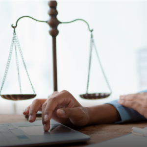 hand on laptop and law balance