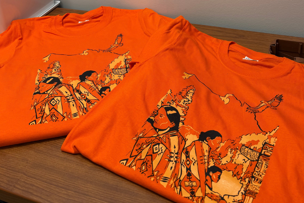 Orange T-shirts folded on a table