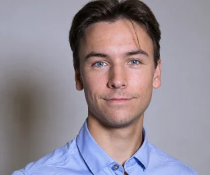 Portrait of a male student with a gray background