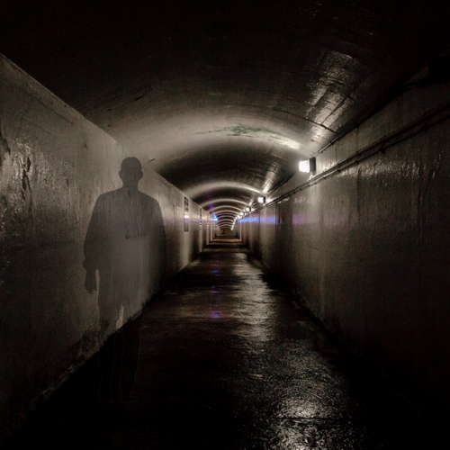 Dark tunnel with shadow of a person