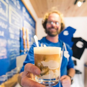 Man showing  a specialty brewed beverage