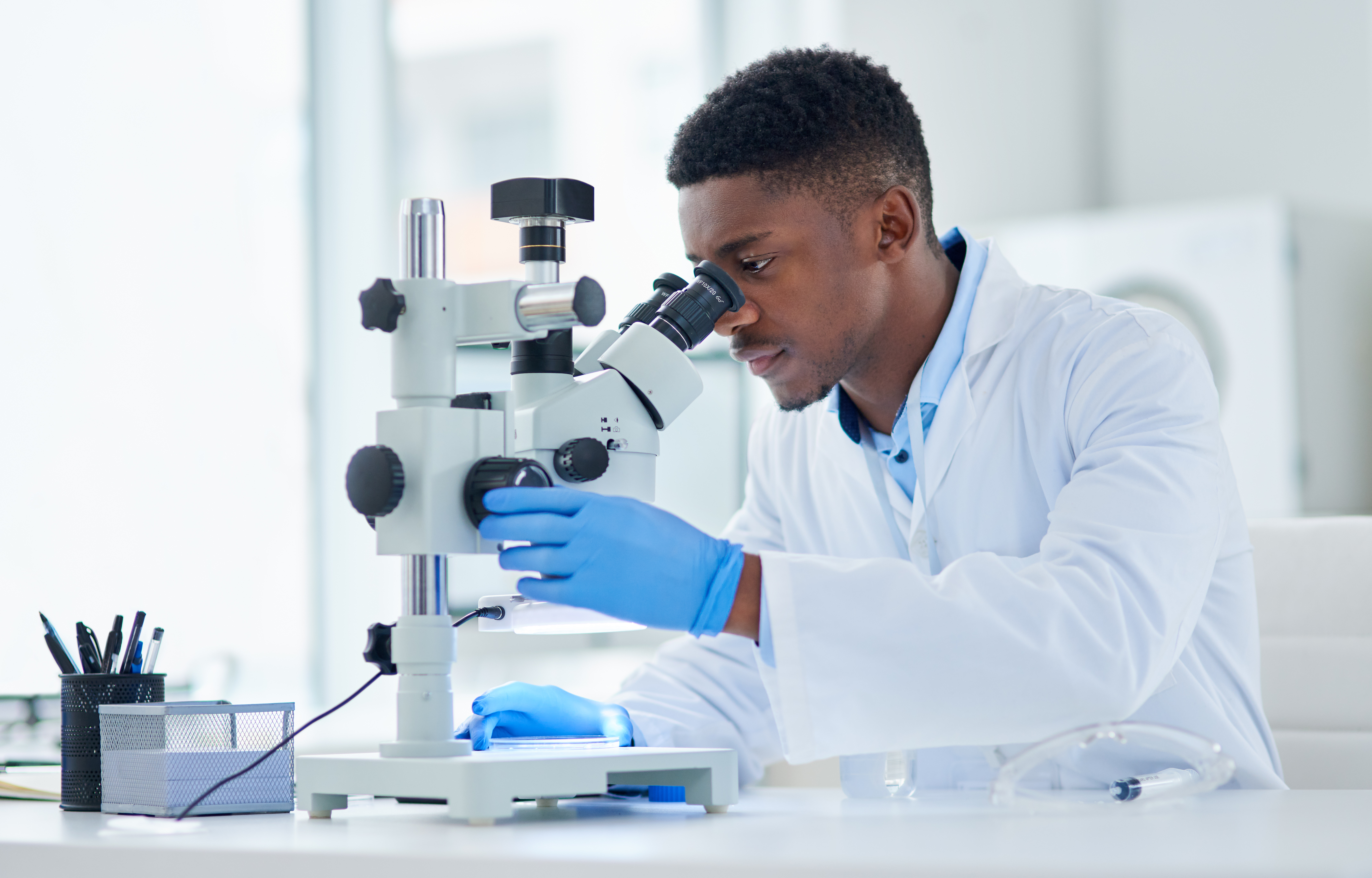 male scientist using a microscope