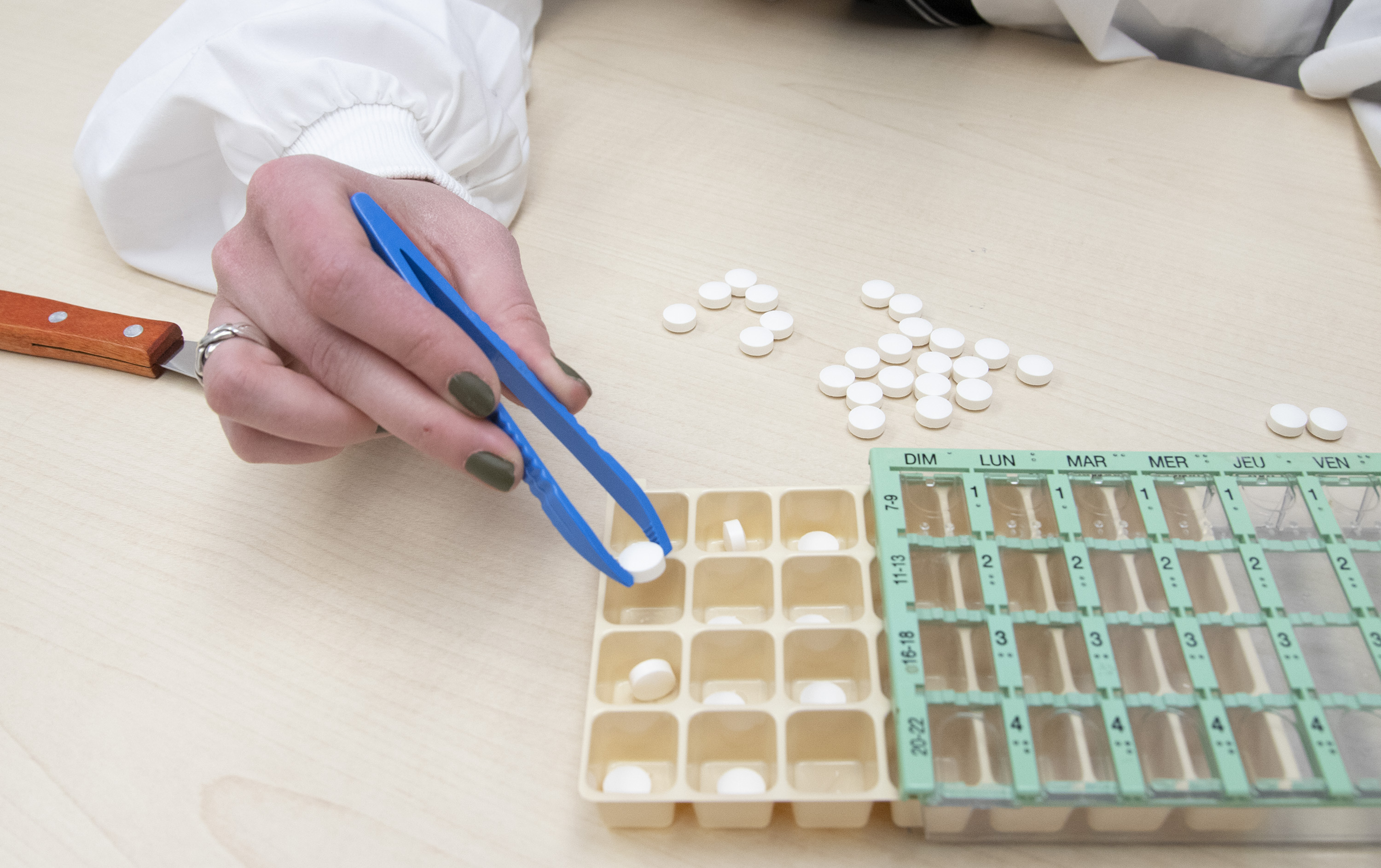 Pharmacist putting pills in a multi-dose packaging