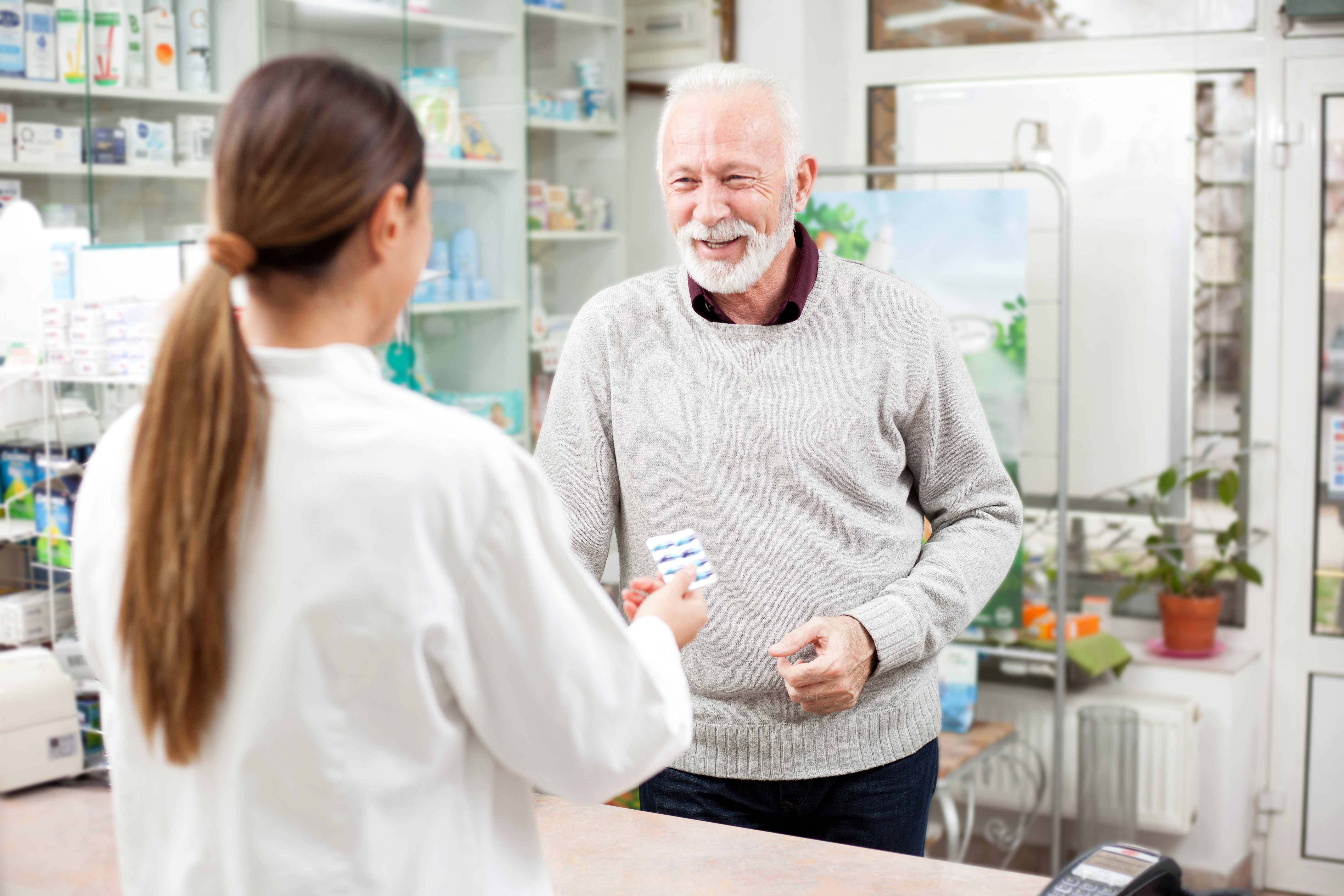 Senior man buying medicine in a pharmacy