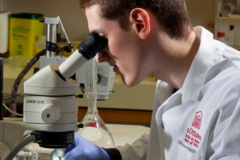 Researcher looking in microscope