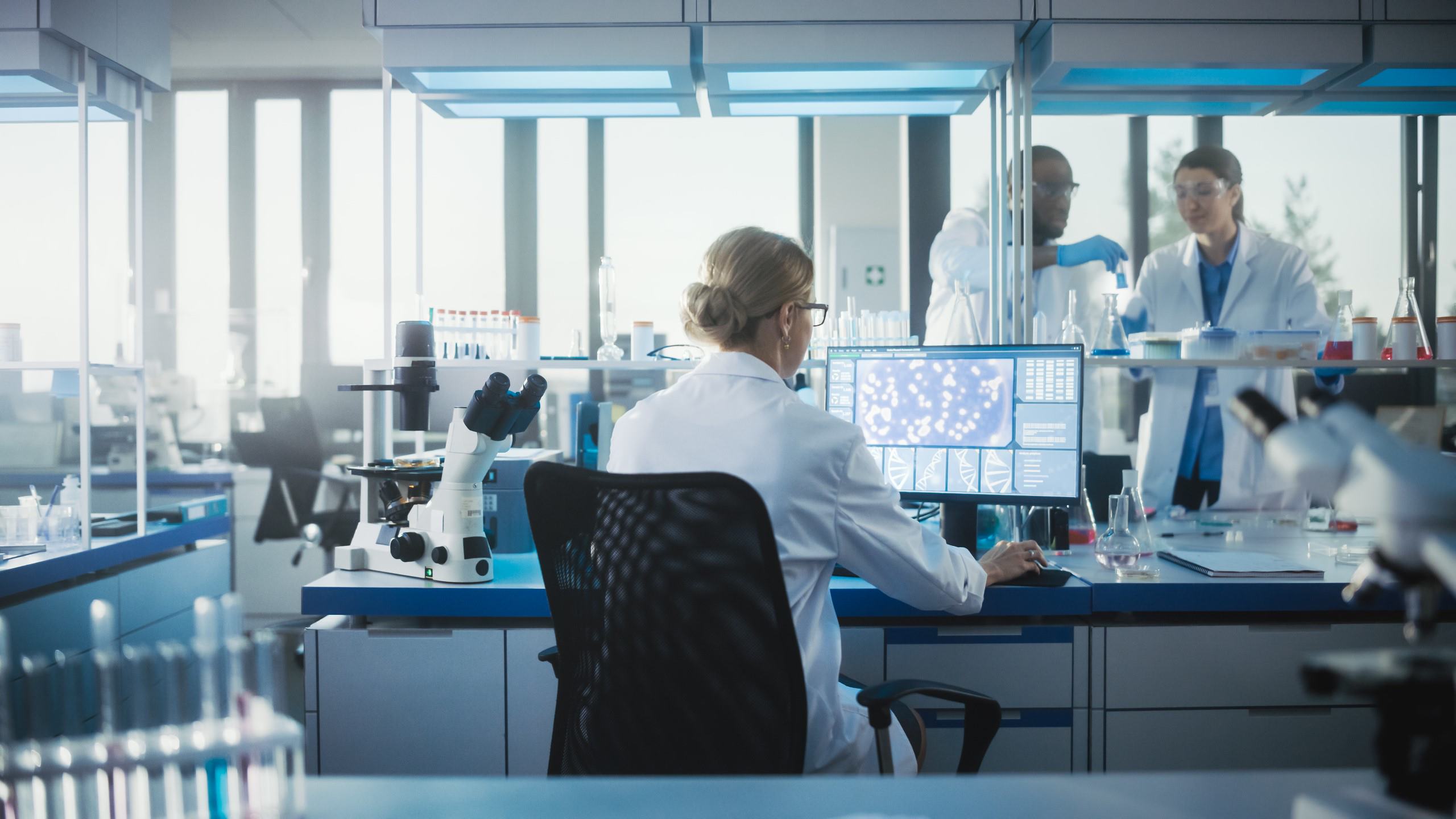 DCMM directory background with scientists working in a lab