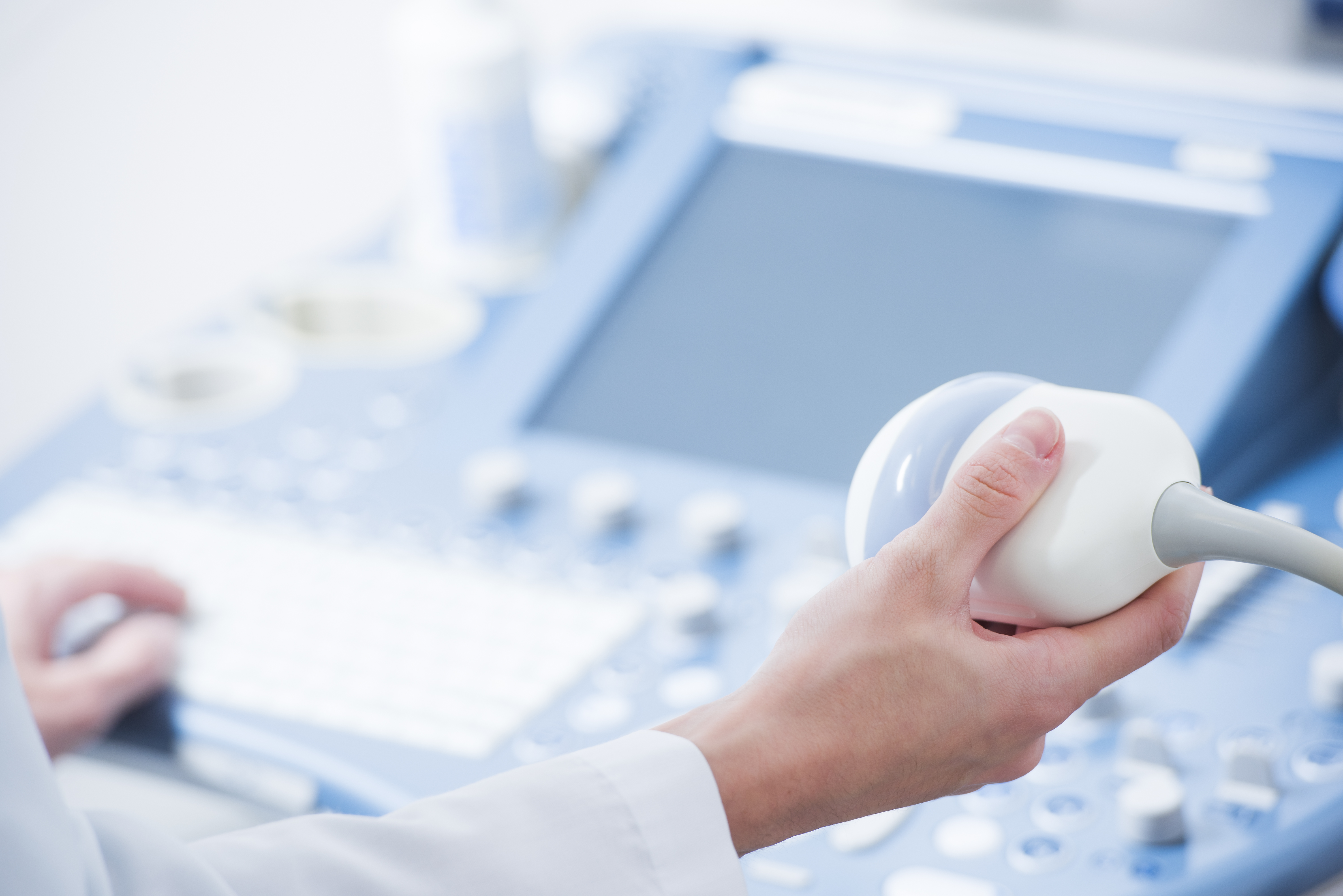 young woman doctor's hands close up preparing for an ultrasound device scan