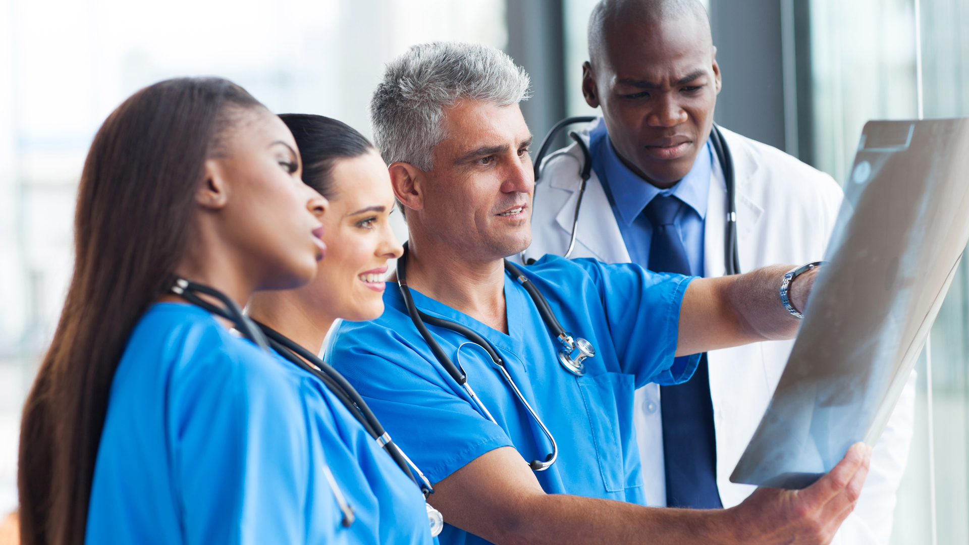 Radiology directory page with doctors looking at the x-ray results