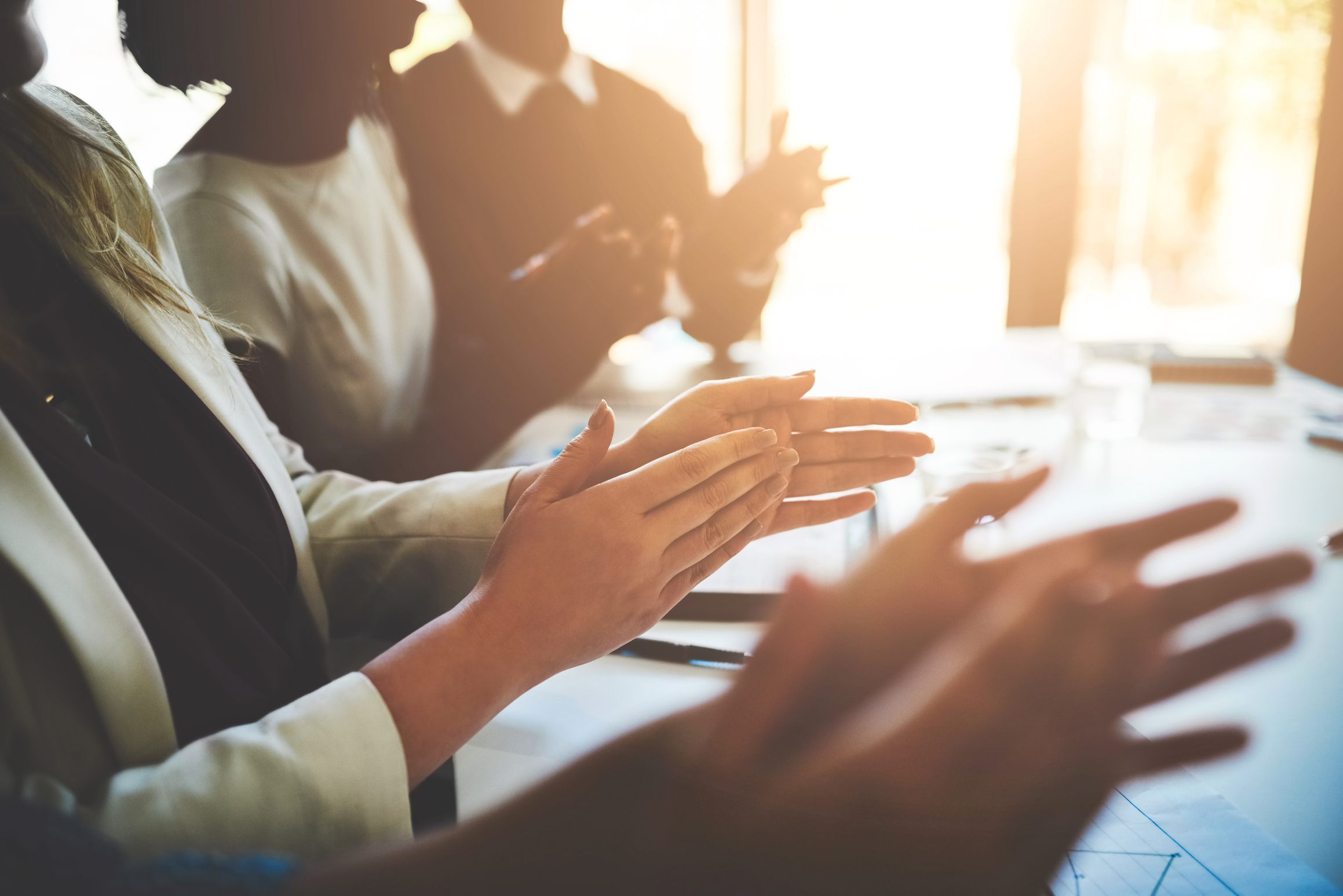 Cropped shot of a group of businesspeople applauding a business presentation