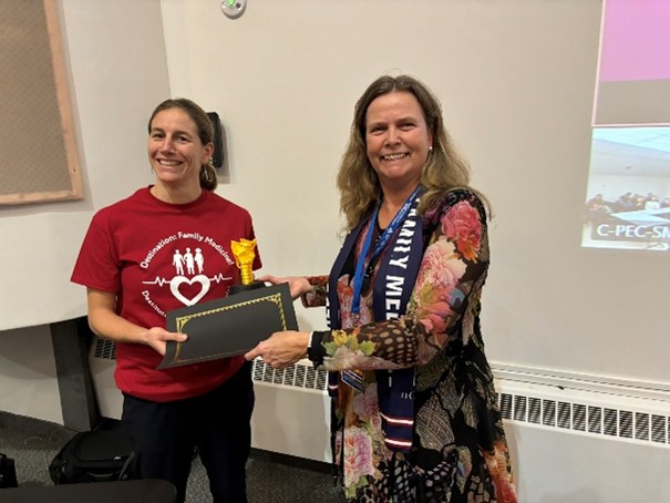 Dr. Liddy awarding Dr. Rifai the Golden Larynx trophy