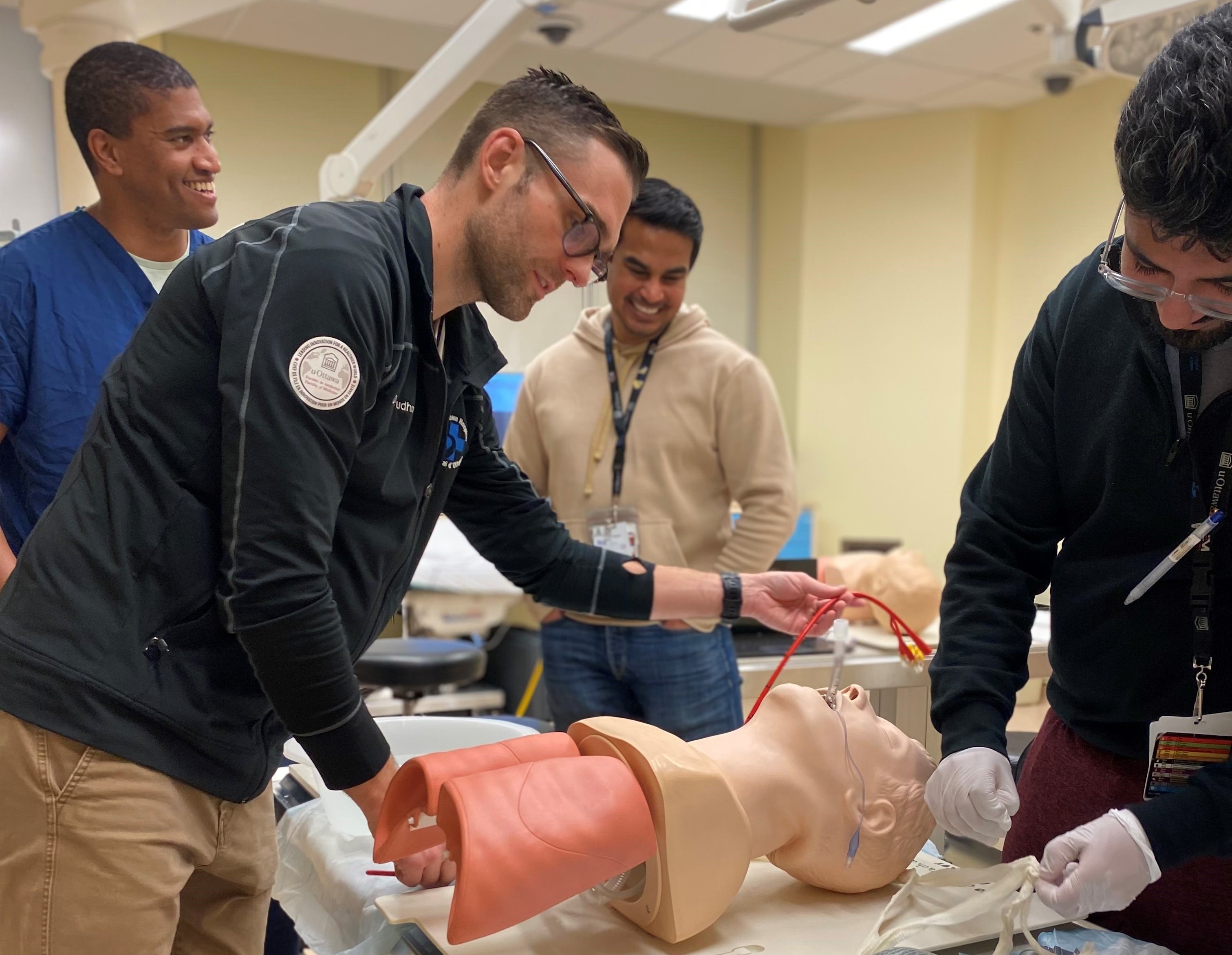 Residents practicing medical treatment on mannequin
