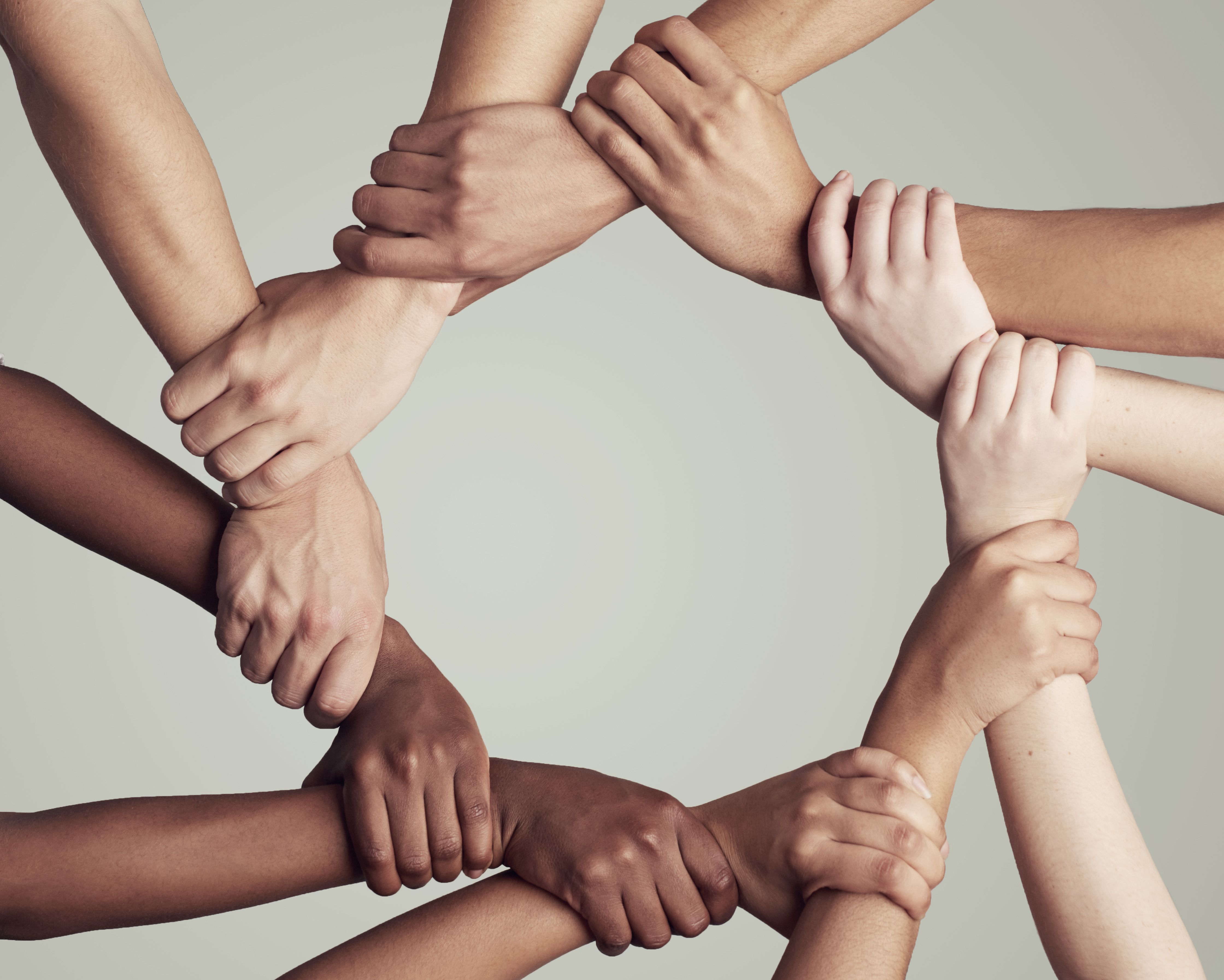 Group of people holding hands in a circle