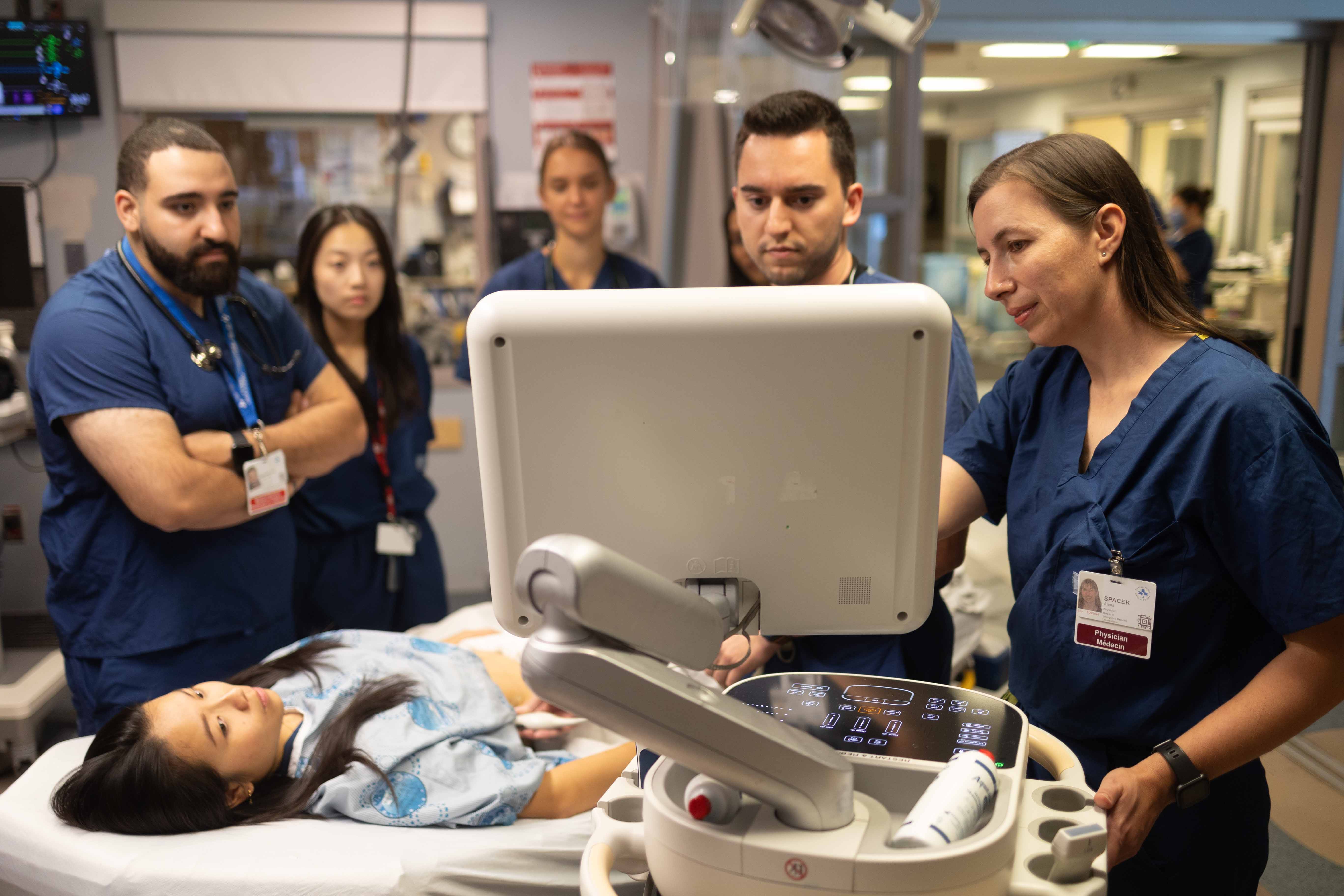 Mentorship - staff teaching residents at screen