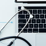 Stethoscope on top of laptop keyboard 