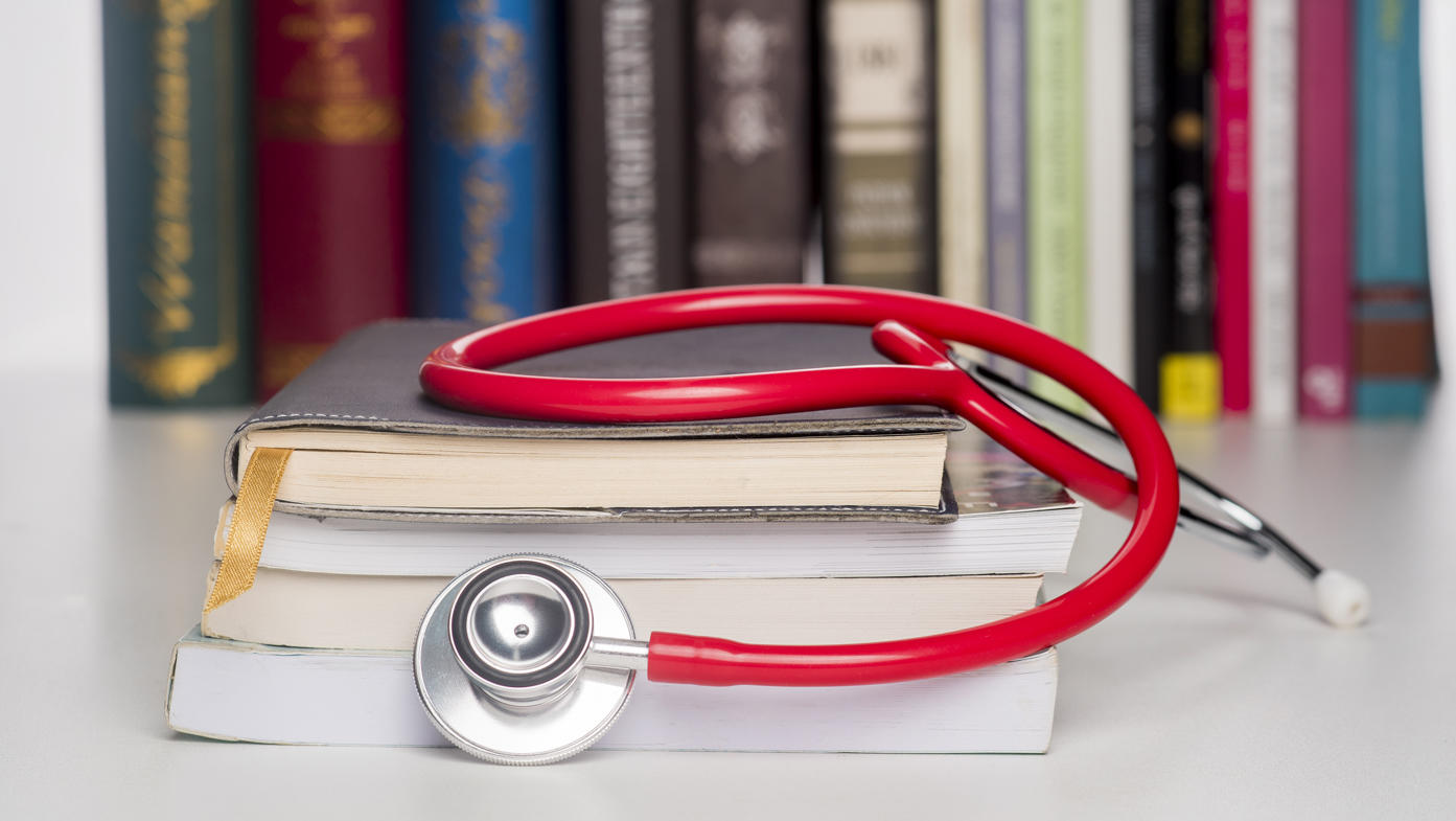 Stethoscope on top of books.