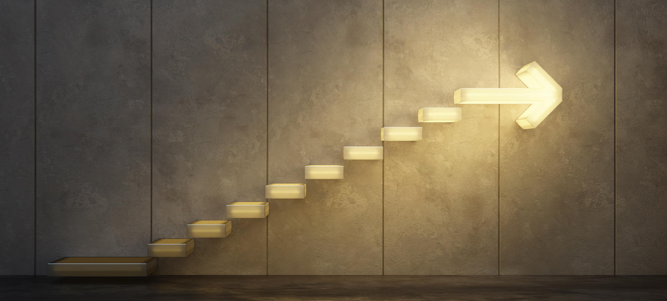 Lighted stairs climbing upwards with lighted arrow at the top of the stairs pointing right