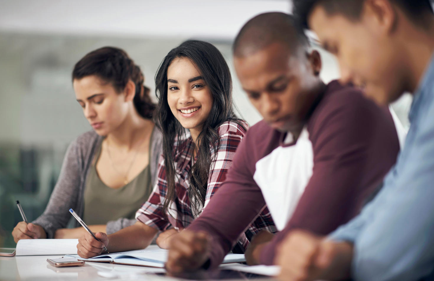 a group of young men and women studying together.