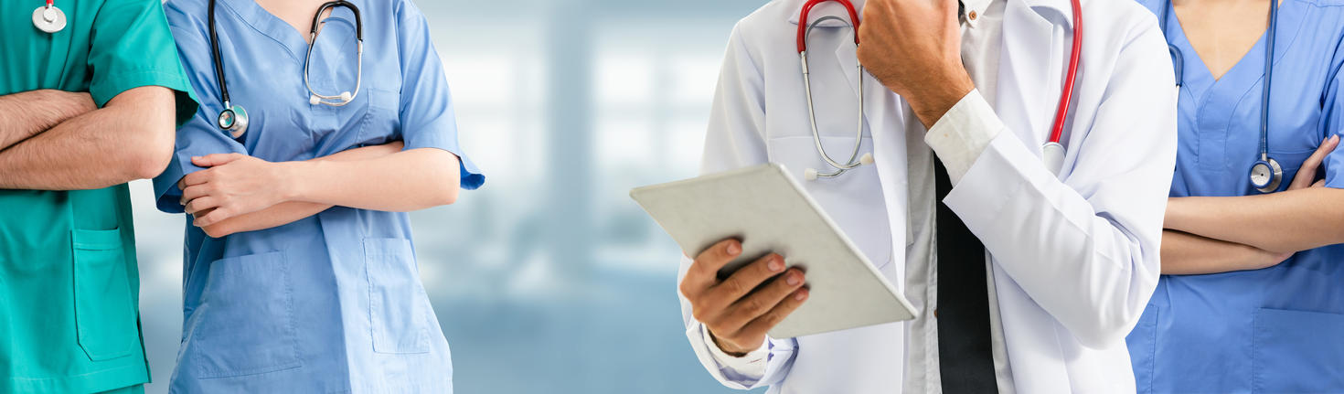 Doctor working in hospital with other doctors