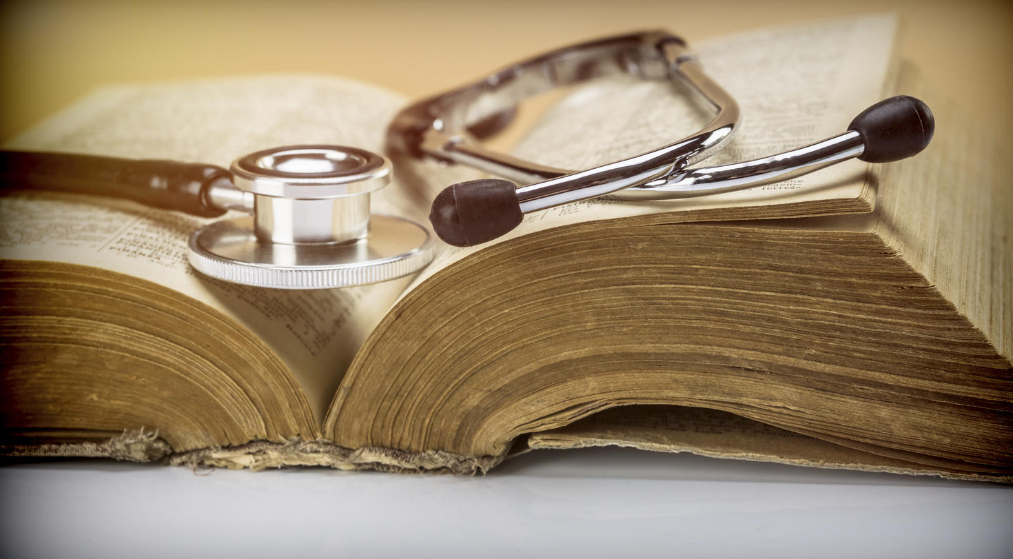 stethoscope on an old book of medicine