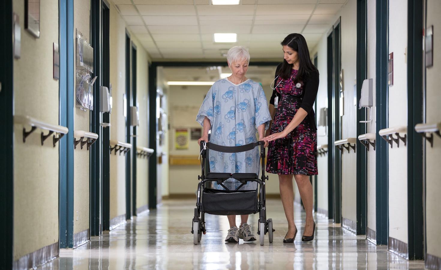 Young female medical doctor taking care of an elderly male patient.